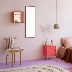 a bedroom with pink walls and purple flooring, a white rug on the floor