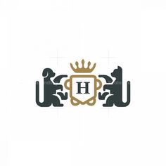 the letter h with two dogs and a crown on it's head is shown