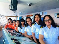 a group of women in uniform sitting at a counter