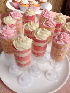 several cupcakes are arranged on a white plate