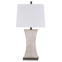 a table lamp with a white shade on it