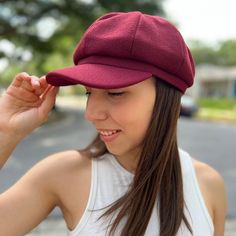 a woman wearing a red hat and white tank top