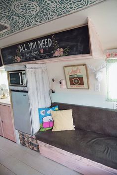 a couch in front of a chalkboard with the words all you need on it