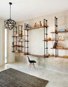 a living room with shelves filled with books and figurines