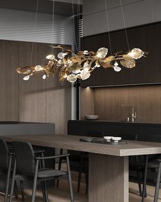 an elegant chandelier hangs from the ceiling above a dining table with black chairs