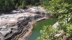 a river flowing between two large rocks in the woods