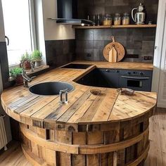 a kitchen with an island made out of wooden barrels