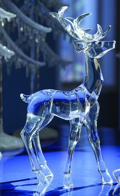 a crystal deer figurine on a blue surface