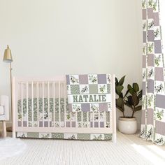 a baby crib next to a potted plant