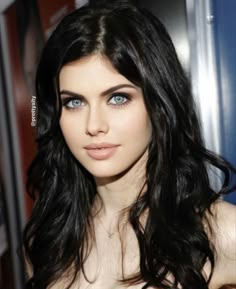 a woman with long black hair and blue eyes