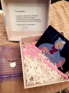 an open box containing jewelry and a card saying to tame is sitting on a bed