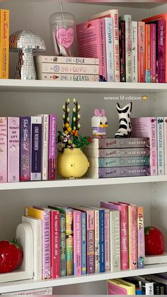 a book shelf filled with lots of books next to an apple and other assorted items