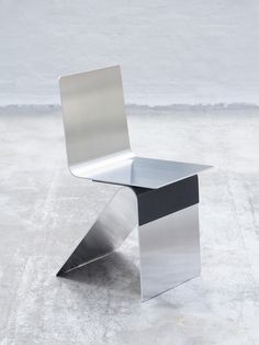 a metal chair sitting on top of a cement floor