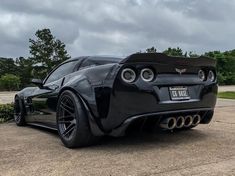 the rear end of a black sports car