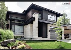 a modern house with grass and trees in the front yard