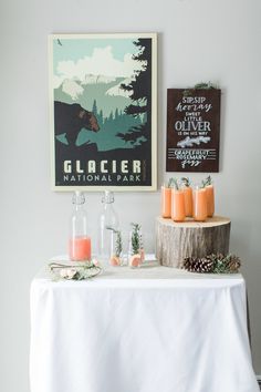 there is a table with candles on it in front of a poster and other decorations