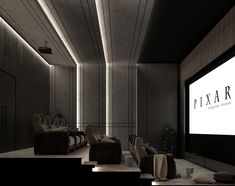 an empty theater with chairs and a projector screen in the middle of the room