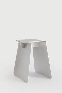 a white table that is sitting on the ground