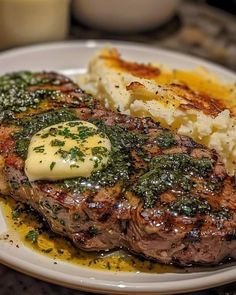 a plate with steak, mashed potatoes and gravy