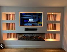 a flat screen tv mounted to the side of a wall next to a fire place