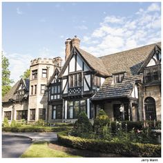 a large house with many windows and lots of bushes