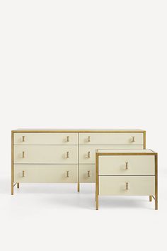 two white dressers with gold handles against a white background