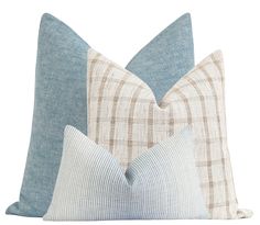 two blue and white pillows sitting next to each other