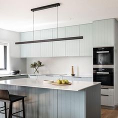 a kitchen with an island and two stools