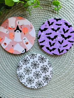 three halloween coasters sitting on top of a table