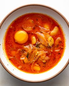 a bowl filled with soup and an egg on top