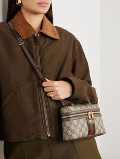 Gucci's 'Ophidia' bag resembles a vintage vanity case. It's made from signature monogrammed coated-canvas contrasted by leather trims and has the label's red and green webbing and gold-tone 'GG' emblem. Stow your cardholder, phone and a few cosmetics inside. Gucci Ophidia Shoulder Bag, Vintners Daughter, Gucci Coat, Gucci Ophidia, Gucci Logo, Monogram Pattern, Vanity Case, Vintage Vanity, Beige Fabric