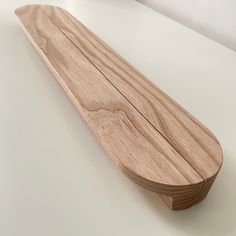 a wooden object sitting on top of a white table