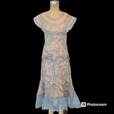 Lovely late 1920s/cuspy to early 1930s pullover day dress made up of near sheer floral print cotton (voile?) and organdy in a blush beige and sky blue. Small at the bust (to fit 32/33) with a roomier waist and kicky flare towards and at the hem. Freshly hand laundered and air-dried and ready to wear.  No issues.  The ruched or ruffled trim could be fluff steamed a bit more. Sleeveless with an oversized portrait collar. A whisper light ethereal day dress in excellent condition. Shown on a 32-23-33 form. Fits well but the style/cut of the dress allows for a little more room at the waist and hips. The fit should skim, not be fitted.  Dress measurements are taken outside of the garment while flat.  Your measurements should be a little smaller.  Across the front of the bust while flat, just to Sleeveless Vintage Dress For Spring Events, 1920s Style Spring Daywear Dresses, Historically Accurate 1920s Dress, 1920s Floral Dress, 1920s Cotton Dress, 1920s Day Dress, 1920s Extant Dress, Dress Measurements, Cotton Voile