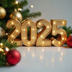 the numbers 2055 are lit up in front of christmas decorations and baubles