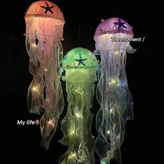 three jellyfish lights in the dark with stars on their heads and underbellies