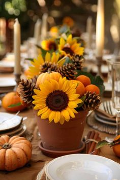 the table is set with sunflowers and pumpkins