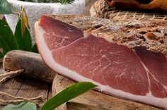 raw meat sitting on top of a wooden cutting board