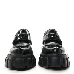 This is an authentic pair of PRADA Spazzolato Triangle Logo Monolith Pointy 55mm Loafers size 38 in Black. These chic platform loafers are crafted of shiny black calfskin leather. They feature pointed toes, triangle Prada logo plaques, and stacked black rubber heels on matching rubber platform soles. Prada Logo, Platform Loafers, Triangle Logo, Rubber Heels, Black Rubber, Calf Skin, Prada, Loafers, Heels