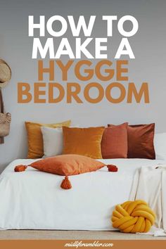 a bed with pillows and blankets on it in front of the words how to make a hygge bedroom