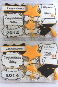 two decorated graduation cookies in plastic wrappers with congratulations written on the front and back