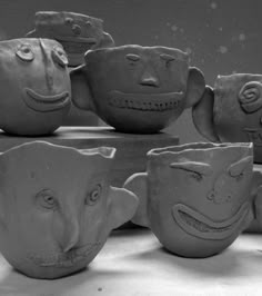 several clay faces are placed next to each other