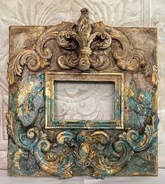 an ornate gold and green photo frame on a white wall with peeling paint overlay