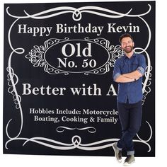 a man standing next to a sign that says happy birthday kevin old no 50