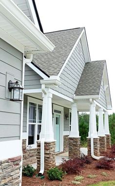 a row of houses with white pillars and windows