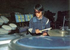 a young man is playing drums in a recording studio