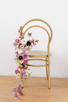 a chair decorated with flowers and ribbons