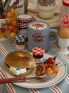 a plate with food on it sitting on a table next to cups and utensils