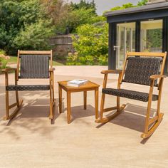 two rocking chairs and a small table on a patio