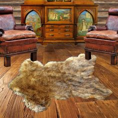 an animal skin rug is on the floor in front of two leather chairs and a dresser