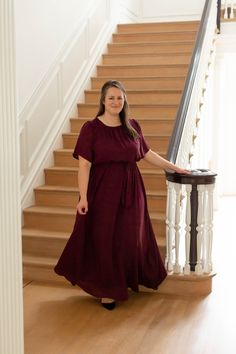 Elegant and feminine, the 'Alexandra' Maxi Dress is perfect for any dressy occasion! This dress features a modest crew neckline, flowy sleeves, a tie waistband and it is fully lined! Pair with wedge sandals for a wedding, a denim jacket and booties for a Sunday morning, or style with fun accessories for a photoshoot. The possibilities are endless! This beautiful dress was made exclusively with you in mind! Self & Lining100% Polyester Hand Wash Cold Do Not Bleach Lay Flat to Dry Low Iron if Neede Simple Modest Outfits, Modest Plus Size, Gig Em Aggies, Ankle Dress, Maroon Dress, Fun Accessories, Flowy Sleeves, Rust Dress, Layered Tops